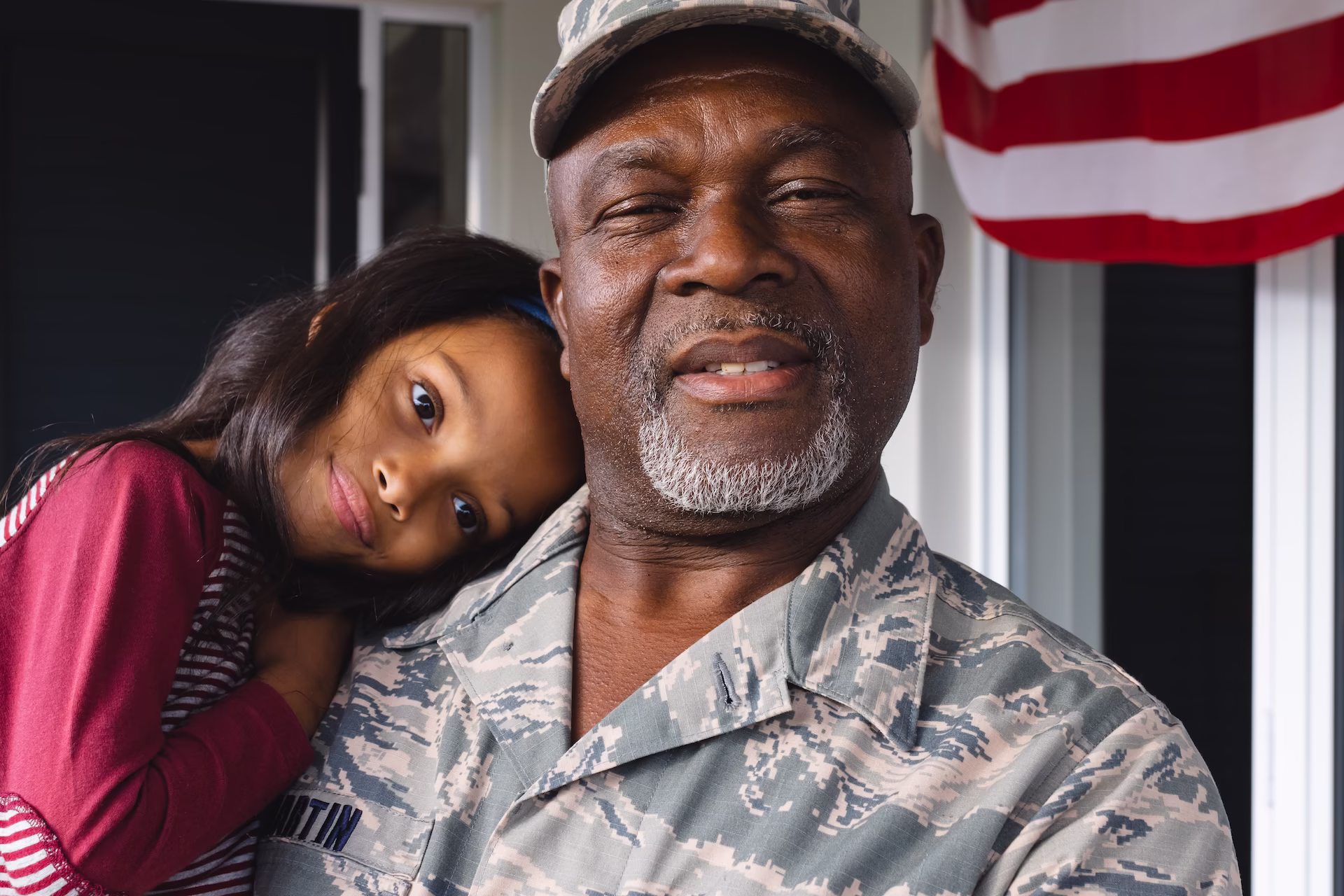A veteran holding his young daughter